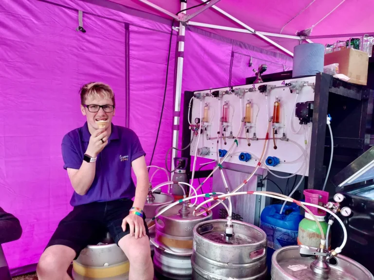 Matt sitting on a keg eating an ice cream.