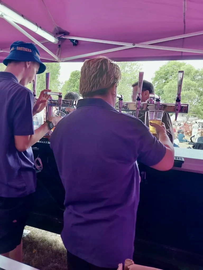 Staff pouring drinks from taps.