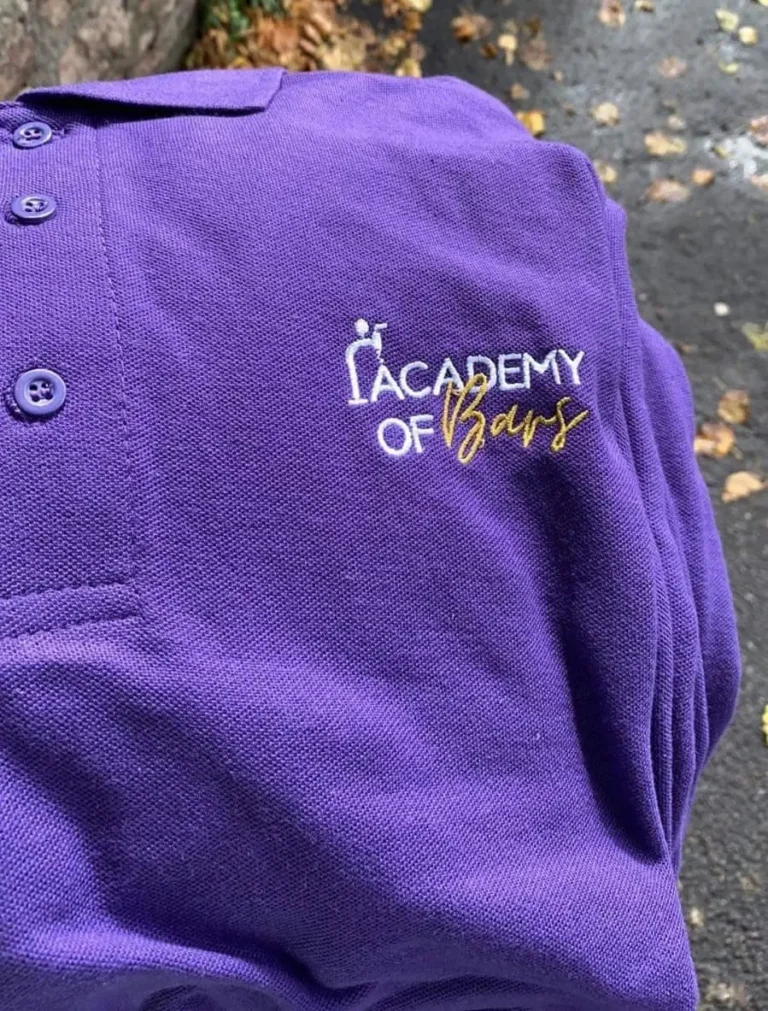 The Academy of Bars polo shirt with logo.