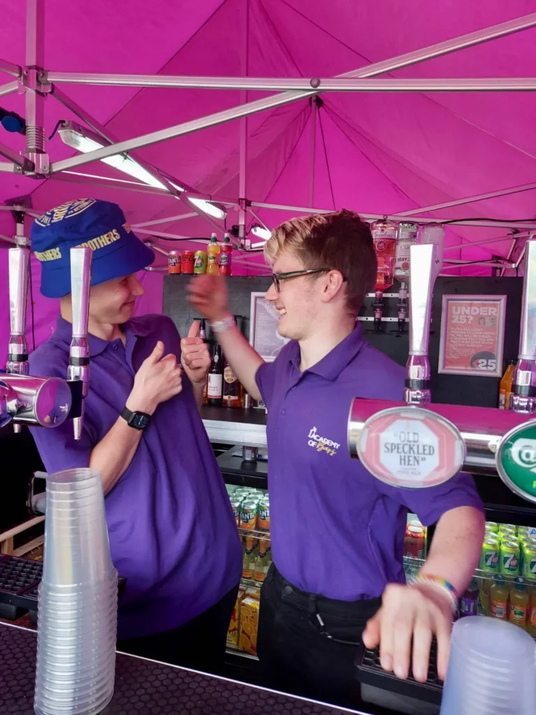 Sam and Matt standing behind the bar.