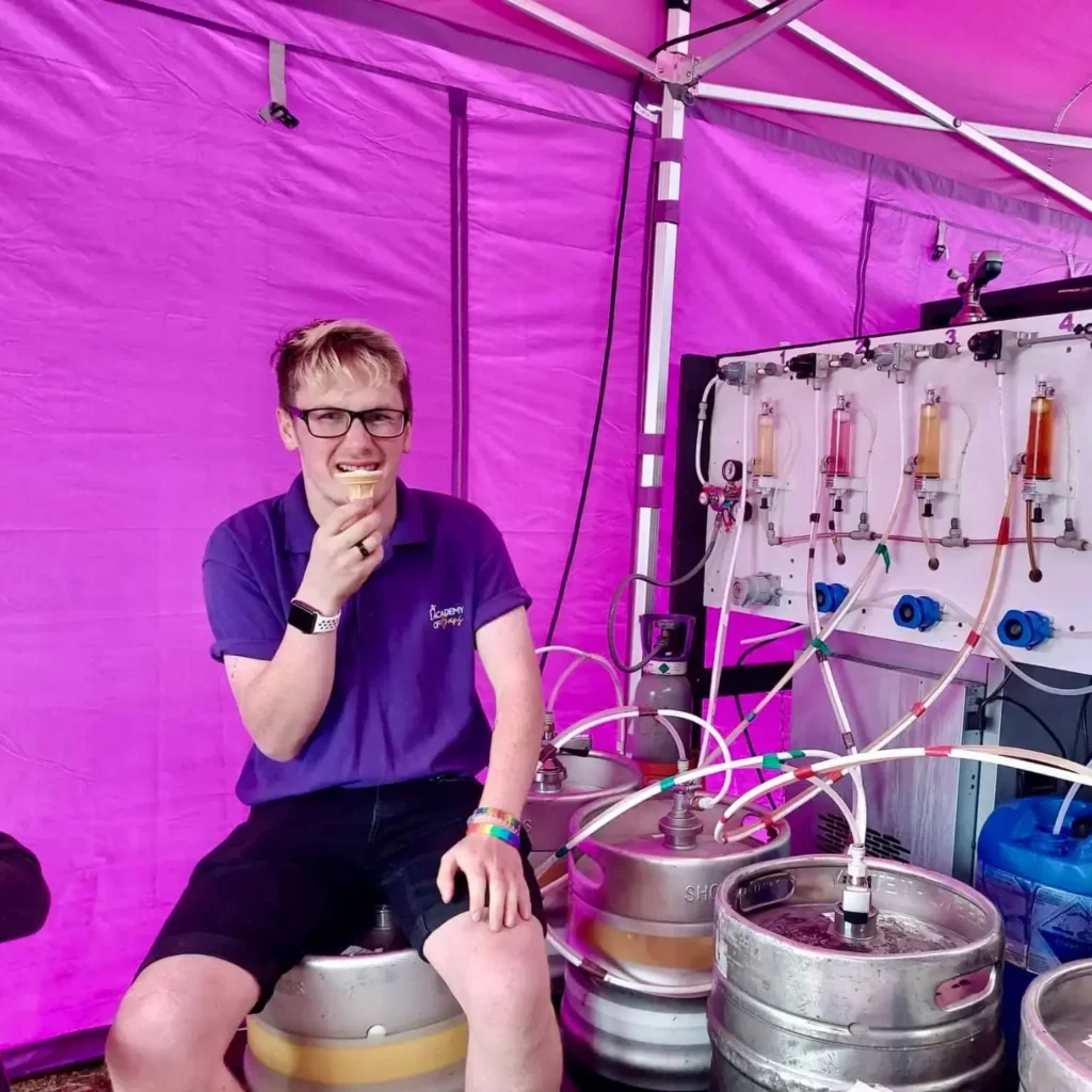 Matt sitting on a keg eating an ice cream.