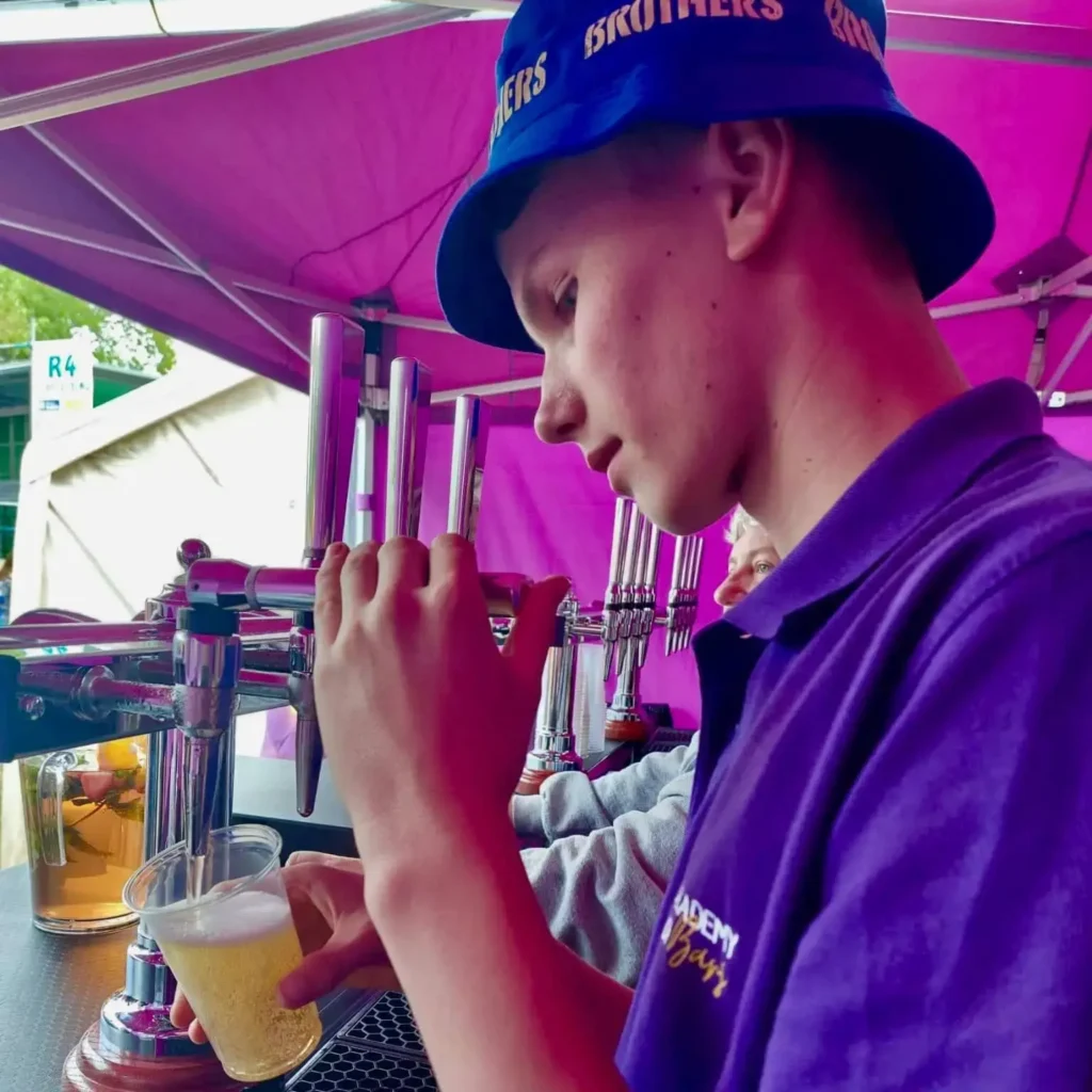 Sam pouring a pint at the taps.