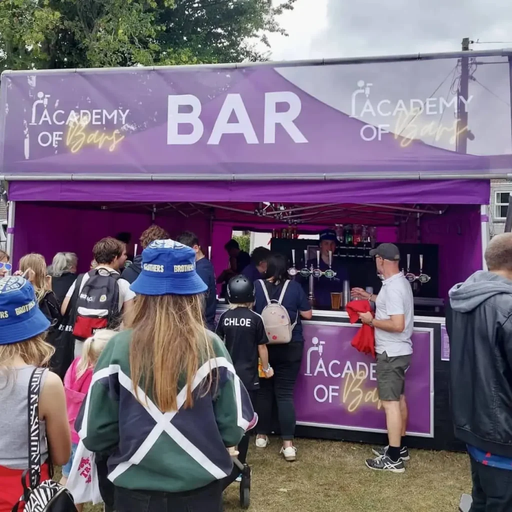 Staff serving people at the bar.