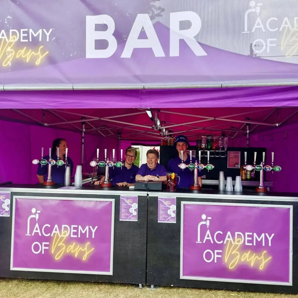 Academy of Bars staff stood behind the bar.